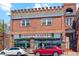 Street view of Spinelli's Market, showcasing the building's brick facade, signage, and street parking at 2844 Bellaire St, Denver, CO 80207