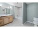Bathroom with a shower-tub combo, wood vanity, neutral gray walls, and hexagon pattern floors at 3890 S Dayton St # 105, Aurora, CO 80014