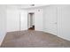 Bedroom featuring neutral carpeting, access to closet, and white doors at 3890 S Dayton St # 105, Aurora, CO 80014