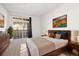 Serene bedroom featuring a comfortable bed, balcony access, and ample natural light, creating a relaxing retreat at 3890 S Dayton St # 105, Aurora, CO 80014