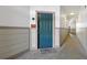Condo entrance with teal door, 'Welcome Friends' mat, and unit number 105 visible at 3890 S Dayton St # 105, Aurora, CO 80014