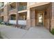 Ground floor entrance of brick condo building featuring a covered patio at 3890 S Dayton St # 105, Aurora, CO 80014