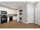 Well-lit kitchen with stacked washer and dryer, stainless steel appliances, and white cabinets at 3890 S Dayton St # 105, Aurora, CO 80014