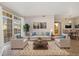 Bright living room with plush seating, decorative rug, and sliding glass doors to a balcony at 3890 S Dayton St # 105, Aurora, CO 80014