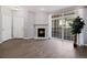 Spacious living room featuring a fireplace, large sliding glass doors, and modern flooring at 3890 S Dayton St # 105, Aurora, CO 80014