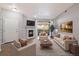 Elegant living room with a fireplace, plush seating, and a sliding glass door leading to a balcony with great views at 3890 S Dayton St # 105, Aurora, CO 80014
