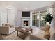 Cozy living room featuring a fireplace, large windows, and comfortable seating, perfect for relaxing and entertaining at 3890 S Dayton St # 105, Aurora, CO 80014