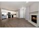 Living area showcases wood-look flooring and flows into a modern kitchen and cozy fireplace at 3890 S Dayton St # 105, Aurora, CO 80014