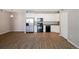 Bright living space featuring stainless steel appliances, black oven, and sleek wood flooring at 3890 S Dayton St # 105, Aurora, CO 80014