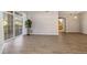 Open living area with wood flooring, sliding doors, and glimpses of a well-lit bathroom at 3890 S Dayton St # 105, Aurora, CO 80014