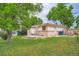 View of home's backyard, showing generous lawn space, patio and mature trees at 5274 Alkire St, Arvada, CO 80002