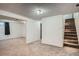 Spacious basement area with carpet, white walls, and staircase at 5274 Alkire St, Arvada, CO 80002