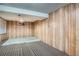 Finished basement area with wood paneling and carpeting at 5274 Alkire St, Arvada, CO 80002