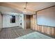 Cozy carpeted basement with wood paneling, projector screen, and unique lighting at 5274 Alkire St, Arvada, CO 80002