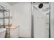 Bathroom featuring a modern standup shower and white marbled sink at 5274 Alkire St, Arvada, CO 80002