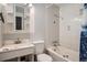 Bathroom with a tile shower/tub combo, mirrored cabinet, toilet and single sink vanity at 5274 Alkire St, Arvada, CO 80002