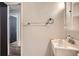 Bathroom with a stainless steel sink faucet, toilet paper roll holder, and neutral wall color at 5274 Alkire St, Arvada, CO 80002