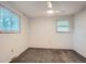 This bright bedroom with windows features neutral colored walls and carpeting at 5274 Alkire St, Arvada, CO 80002