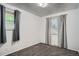 This cozy bedroom features neutral walls, plush carpeting, and natural light from two windows at 5274 Alkire St, Arvada, CO 80002
