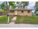 Quaint brick home with a front yard and sidewalk leading to the front door at 5274 Alkire St, Arvada, CO 80002