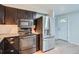 Efficient kitchen with stainless steel appliances, and dark cabinets at 5274 Alkire St, Arvada, CO 80002