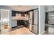Well-equipped kitchen featuring stainless steel appliances and dark cabinetry at 5274 Alkire St, Arvada, CO 80002