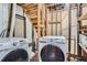 Unfinished laundry room featuring two modern washing machines and plumbing at 5274 Alkire St, Arvada, CO 80002