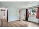 Bright living room features wood floors, fresh paint, and a large window at 5274 Alkire St, Arvada, CO 80002