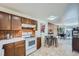 Kitchen with wood cabinets, white appliances, and a breakfast bar at 1518 Chambers Dr, Boulder, CO 80305