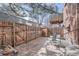 Small patio with wooden fence and seating area at 1518 Chambers Dr, Boulder, CO 80305