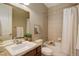 Well-maintained bathroom featuring tiled walls, a shower-tub combination, and updated fixtures at 15265 W Baker Ave, Lakewood, CO 80228