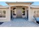 Home featuring an inviting front entrance with stone columns and double front doors at 15265 W Baker Ave, Lakewood, CO 80228