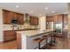 Spacious kitchen with granite countertops, stainless steel appliances, and a large island at 15265 W Baker Ave, Lakewood, CO 80228