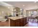 Open-concept kitchen featuring a large island connecting to the dining and living areas at 15265 W Baker Ave, Lakewood, CO 80228