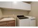 Laundry room with cabinetry, sink, washer and dryer units at 15265 W Baker Ave, Lakewood, CO 80228