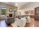 Open-concept living room featuring a fireplace and hardwood floors at 15265 W Baker Ave, Lakewood, CO 80228