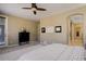 Main bedroom with a ceiling fan and access to bathroom at 15265 W Baker Ave, Lakewood, CO 80228