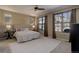 Serene main bedroom with two large windows, ambient lighting, and a comfortable bed at 15265 W Baker Ave, Lakewood, CO 80228