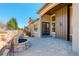 Spacious patio features an outdoor kitchen, stone fire pit, and custom pavers at 15265 W Baker Ave, Lakewood, CO 80228
