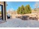 Outdoor patio features stone fire pit, built-in grill, and brick pavers at 15265 W Baker Ave, Lakewood, CO 80228