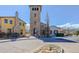 Community featuring custom homes, a stone tower, and mature landscaping at 15265 W Baker Ave, Lakewood, CO 80228