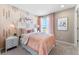 Charming bedroom featuring pink accents, a cozy bed, and natural light at 23782 E 33Rd Pl, Aurora, CO 80019