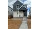 Charming two-story home with gray siding and a welcoming front porch and landscaped yard at 23782 E 33Rd Pl, Aurora, CO 80019