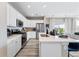 Bright kitchen with stainless steel appliances, white cabinetry, and a central island at 23782 E 33Rd Pl, Aurora, CO 80019
