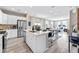 Open-concept kitchen boasts stainless steel appliances, and an island, overlooking the dining and living area at 23782 E 33Rd Pl, Aurora, CO 80019