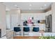 Modern kitchen features white cabinets, stainless steel appliances and a large island with seating at 23782 E 33Rd Pl, Aurora, CO 80019