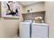 Functional laundry room with modern washer and dryer, plus storage at 23782 E 33Rd Pl, Aurora, CO 80019