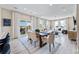 Spacious living room and dining area boasts wood floors, modern furniture and large windows for natural light at 23782 E 33Rd Pl, Aurora, CO 80019