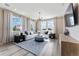 Spacious living room with natural light, modern chandelier, and comfortable sectional sofa at 23782 E 33Rd Pl, Aurora, CO 80019