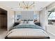 Bright main bedroom featuring a statement wall, bench seat, and natural light from large windows at 23782 E 33Rd Pl, Aurora, CO 80019